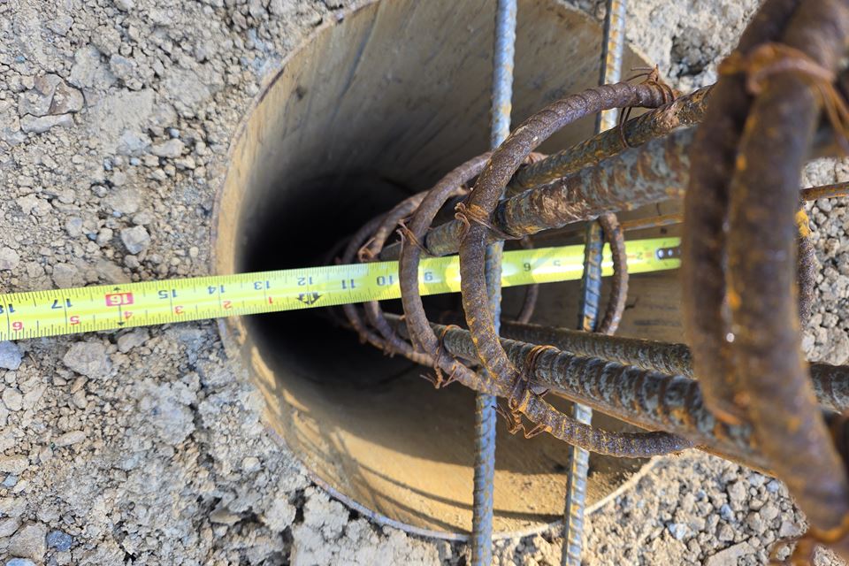 Checking a drilled pier and its rebar cage before the pour