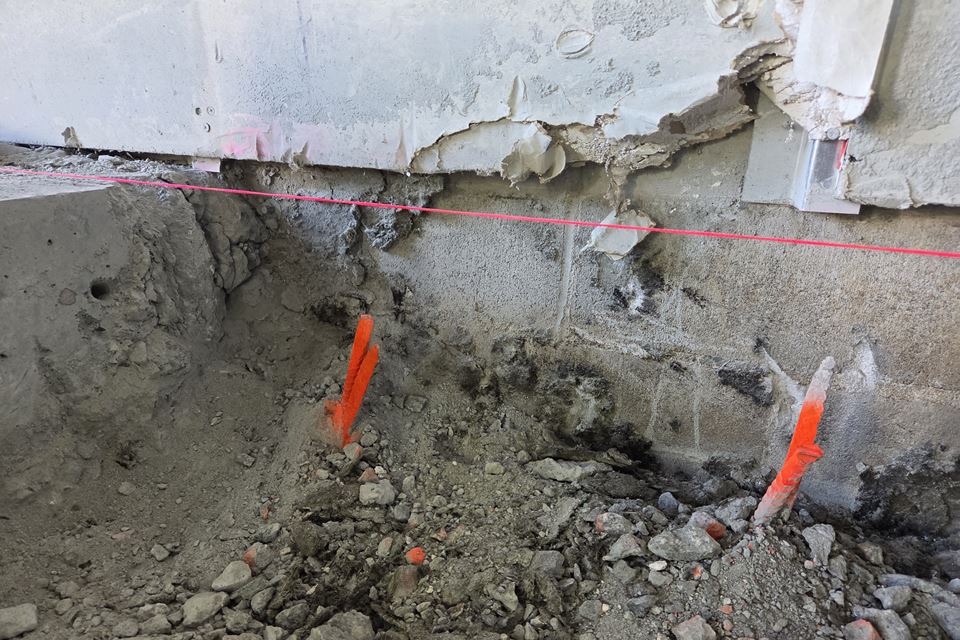 Excavation at an existing footing, checked against a laser line