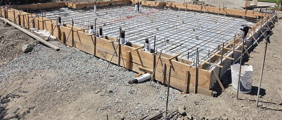 Field engineering: a formed slab with its rebar mat, forms, and stakes before the concrete pour